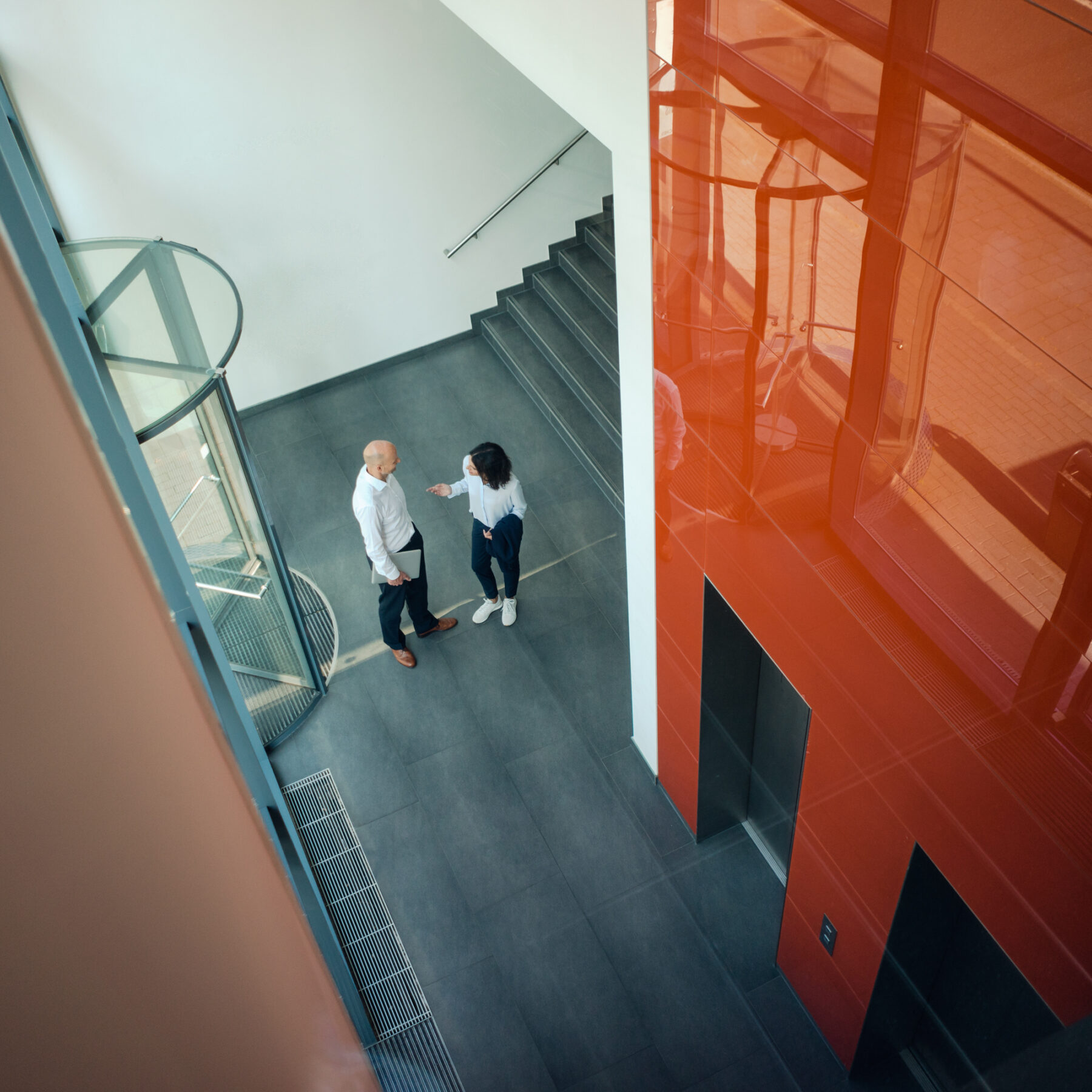 Business people talking in front of elevator