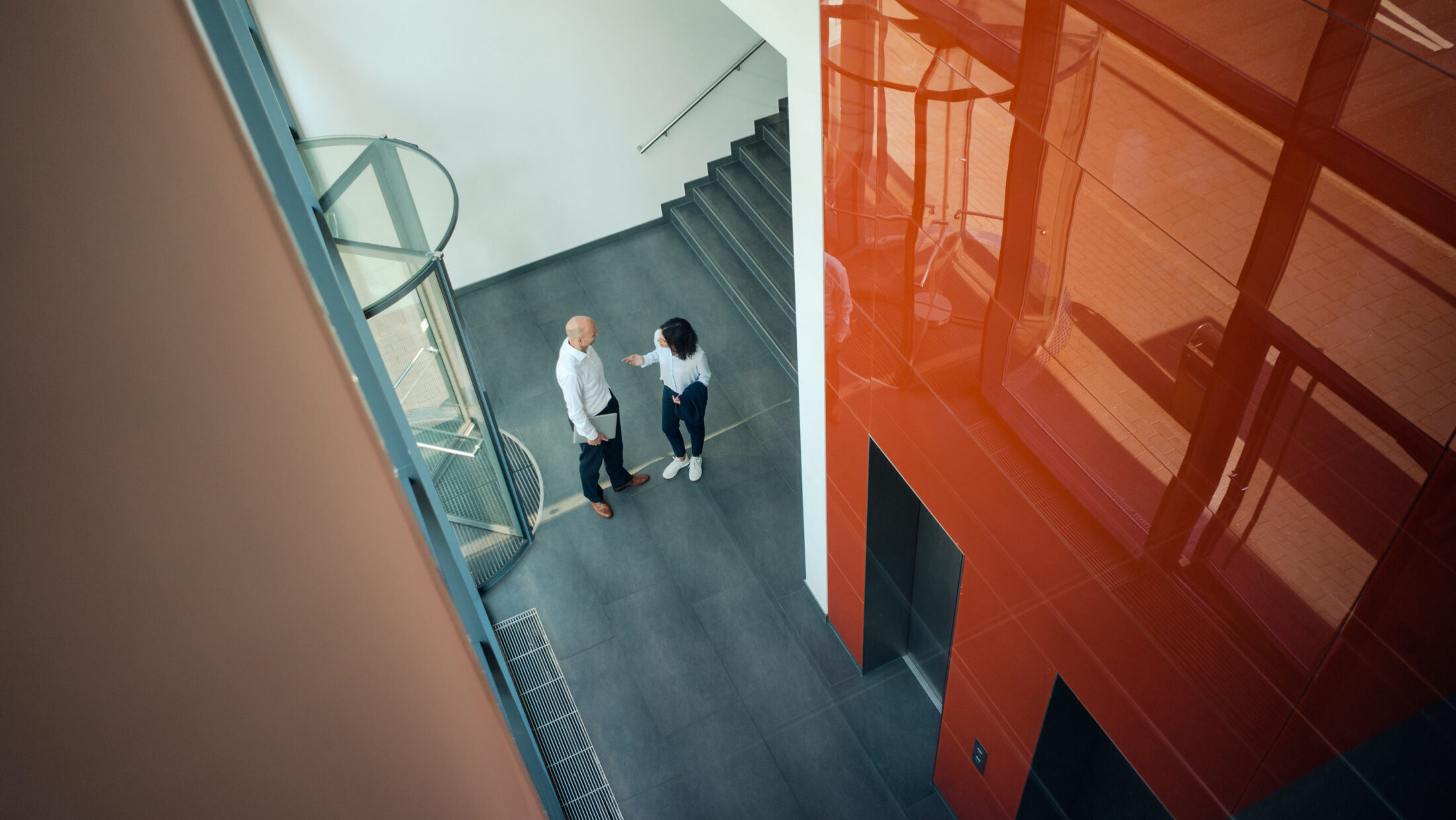 Business people talking in front of elevator