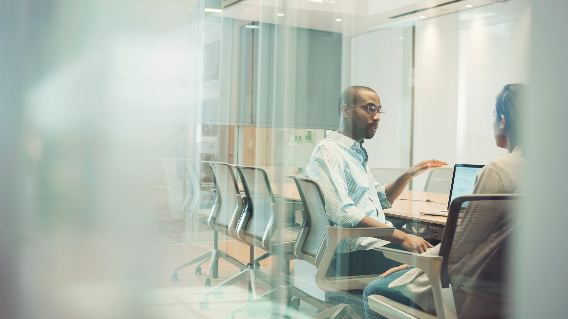 Businessman sitting in office talking to colleague 2022 03 08 01 34 40 utc