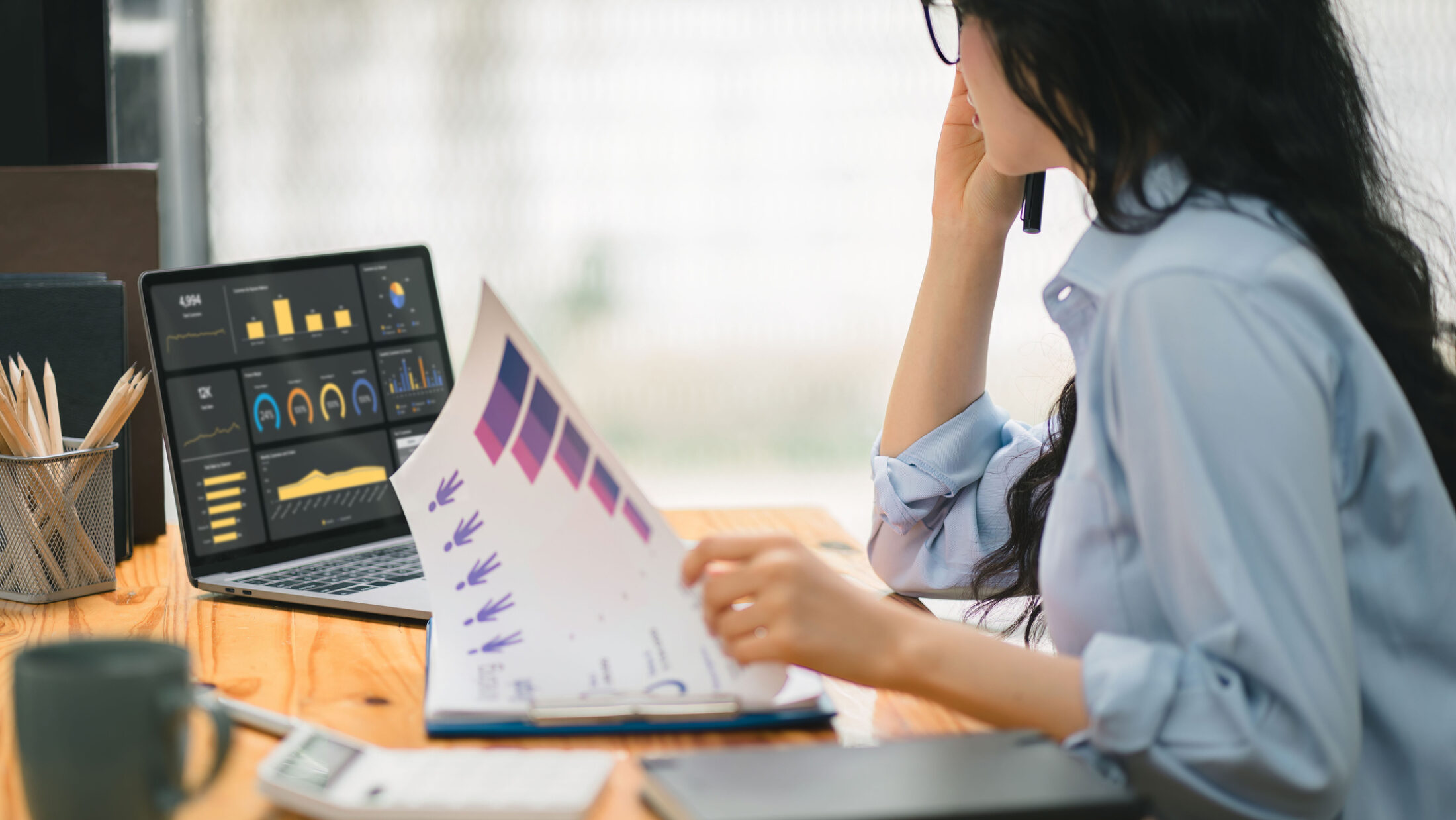 Businesswoman accountant using graphs, and charts to analyze data