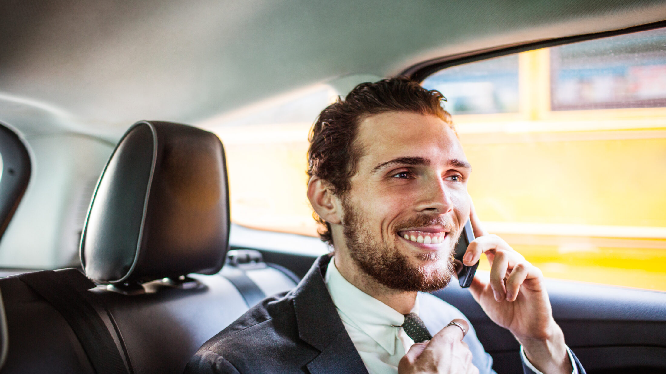 Smiling businessman talking on phone while traveli 2022 03 09 02 30 32 utc